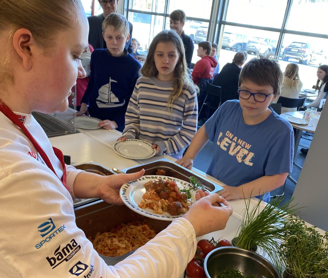 Landslagskokk Anette Myrhagen serverer mat til elevene ved Gaupen skole. – Elevene gledet seg til skolematen og vi har hatt kun positive erfaringer, forteller skolens lærere.