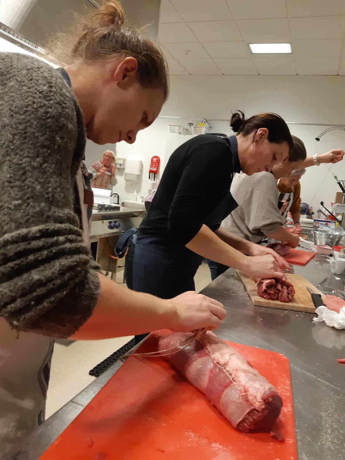 Kvinner står og lager kjøttrull