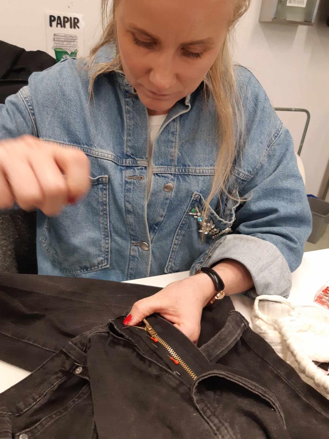 Kvinne forbereder sying av glidelås