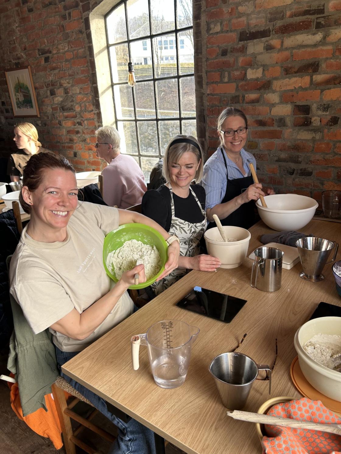 Fornøyde kursdeltakere jobber med deigen