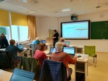 Damene er fullt konsentrerte over datamaskinane. Foto: Omvikdalen bygdekvinnelag